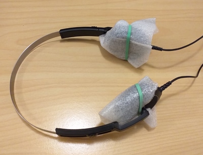 Yaesu heaphones with foam packaging wrap attached to ear pieces with elastic bands.
